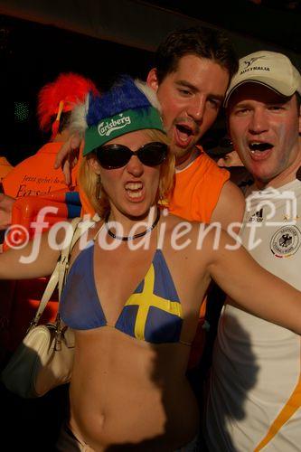 Having fun: Swedish footballfan girl with dutch footballfans in Basel. Eine schwedische Fussballbraut und holländische Fans amüsieren sich köstlich in der Fanzone von Basel