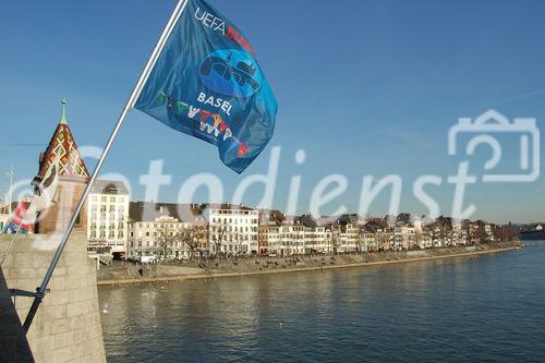 Rheinbrücke in Basel mit Euro 08 Flaggen und Häuserzeile am Flussufer. 
Switzerland, Basel, bridge over rhein-River, Euro 08 flags, people, houses, city, 
