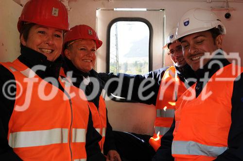 Bergarbeiter/innen fahren mit der Stollen-Bahn zur Alpentranist-Durchstichsstelle. Miners and visitors are drivin in a small train to the break through point of the Gotthard tunnel (new Word record with 57 km)