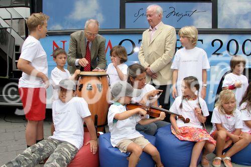 (C) fotodienst/Anna Rauchenberger - Wien 01.08.2006 - Ein bunt gestalteter Doppeldecker-Bus tourt durch Wien. Er bringt Musikinstrumente zum Anfassen und Ausprobieren in Schulen, Kindertagesstätten und andere Jugendeinrichtungen. Das klingende Mozart-Mobil soll Kinder und Jugendliche zum Musizieren animieren. FOTO: Peter Marboe (Intendant WIENER MOZART JAHR 2006, links), Gerd Albrecht (Initiator des Klingenden Museums in Hamburg und Berlin) und begeistete zukünftige Musiker vor dem Klingenden Mozart-Mobil.