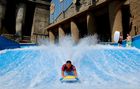 Young men surfing in the water channel, basin of the luxury five star hotel RIXOS in Belek, Antalya, Turkey. Fun, water-sport, holiday, Junger Mann surft im Wasserkanal des Luxus-Hotels RIXOS an der türkischen Riviera in Belek bei Antalya. 