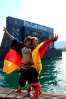 Zwei Deutsche Fussballfan-Frauen posieren freudig wie Engel vor dem TV-Monitor im Zürichsee. German female footballfans posing in front of the TV-Monitor at the lake Zürich.