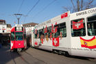 Alles Euro 08 oder was? Die Schweiz im Fussball-Fieber - zumindest die Sponsoren heizen uns jetzt schon kräftig ein. Swiss und Credit Suisse Trämli am Basler Barfüsser-Platz (Barfi). Sport, Fussball Europameisterschafts Spiele Euro Host City, Werbung, Sponsoring UEFA, Öffentlicher Verkehr; public transport publicity euro 08 football 
games in Basel, Airline Swiss and Bank Credit Suisse are sponsoring the Basler Trämli