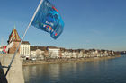 Rheinbrücke in Basel mit Euro 08 Flaggen und Häuserzeile am Flussufer. Switzerland, Basel, bridge over rhein-River, Euro 08 flags, people, houses, city, 