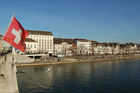 Rheinbrücke in Basel mit Euro 08 Flaggen und Häuserzeile am Flussufer. Switzerland, Basel, bridge over rhein-River, Euro 08 flags, people, houses, city, 