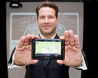 (c) fotodienst / Anna Rauchenberger - Wien, am 30.06.2010 -  TomTom präsentierte heute bei einem Pressefrühstück im Hollmann Salon das neue Navigationssystem TomTom Go 1000 Traffic FOTO: Mag. Rudolf Mayrhofer-Grünbühel, TomTom Country Sales Manager Austria mit dem neuen Navigationssystem TomTom Go 1000 Traffic